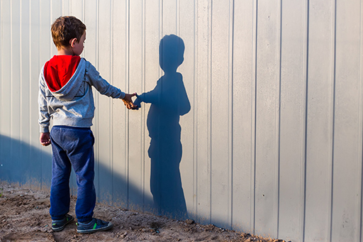 A child looking at their shadow.