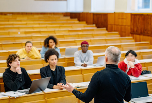 A group of students and a lecturer in a lecture hall.