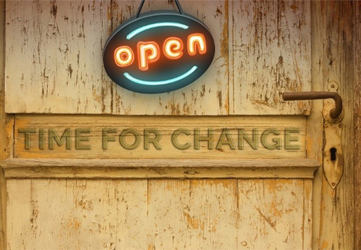A door with the words ‘Open’ and ‘Time for change’ on it.