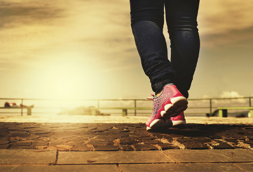 A pair of legs wearing trainers.