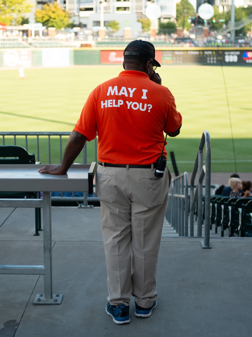 A person with the words ‘May I help you?’ on their back.