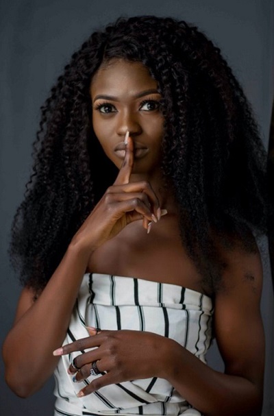 A person with their finger in front of their lips.