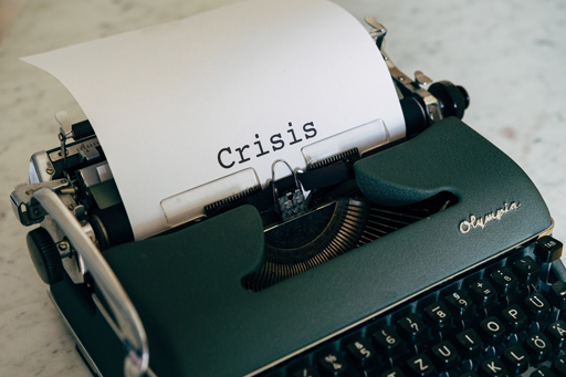 A typewriter with the word ‘Crisis’ typed on a piece of paper.