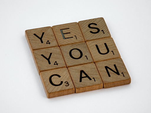 Scrabble tiles spelling out ‘Yes you can’.