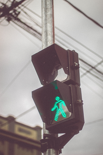 A pedestrian crossing with the green man showing.