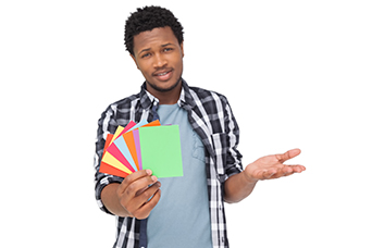 Photo of a man holding several multi-coloured cards.