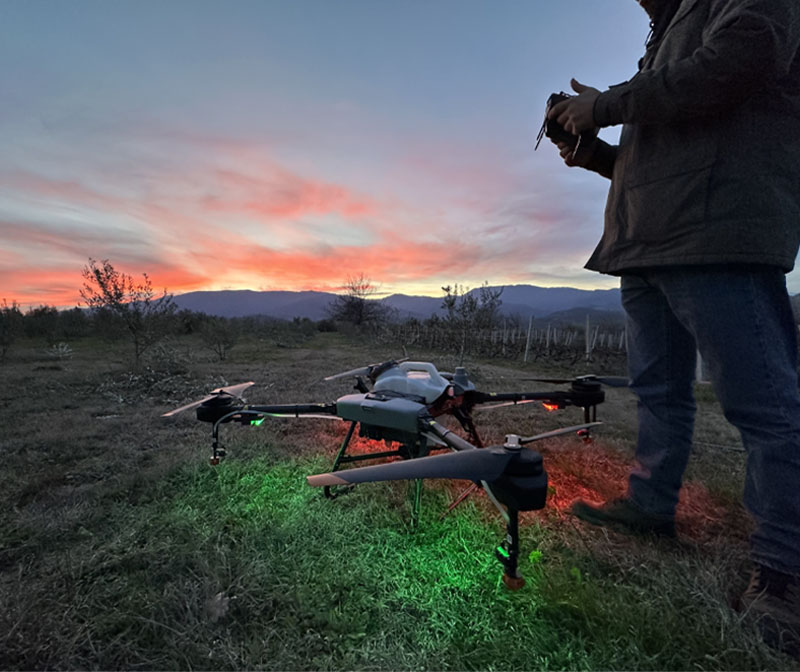 A person using a remote controller next to a drone