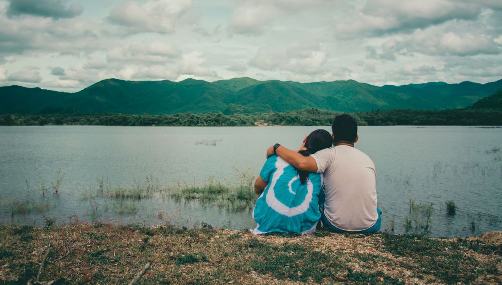 Young people watching the waterfront view mountains and rivers, natural atmosphere