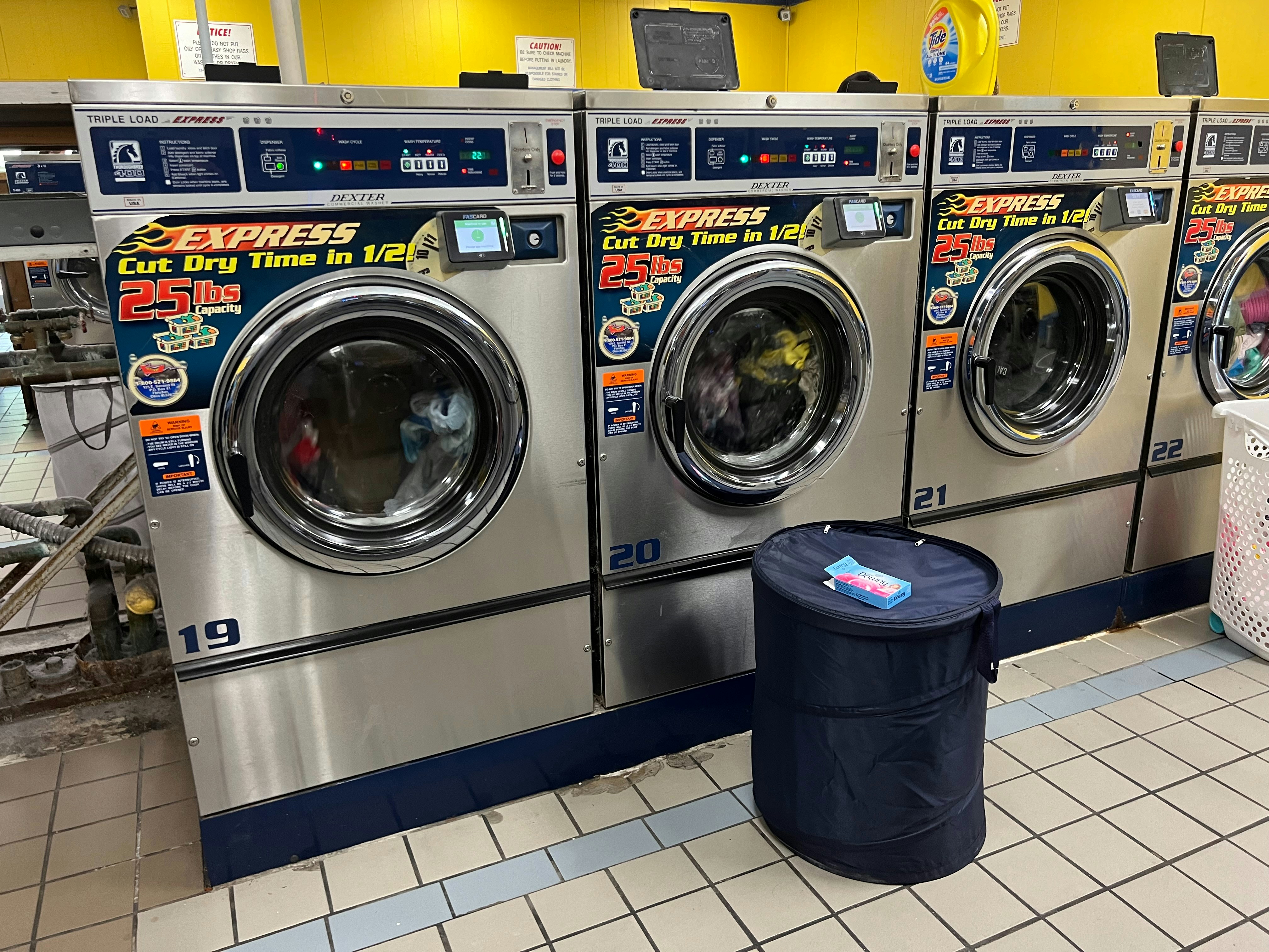 A row of washing machines in a laundrette.