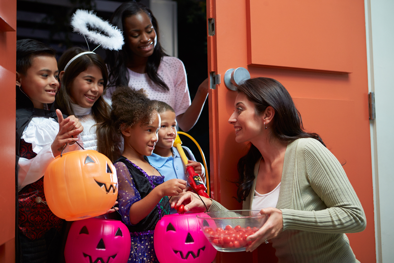 Children going Trick Or Treating with their mother