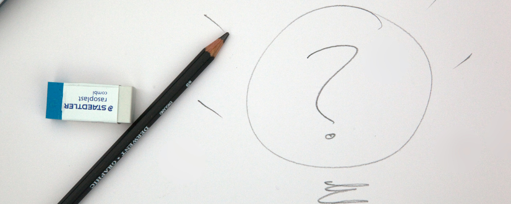 pencil and eraser next to a drawing of a question mark in a lightbulb
