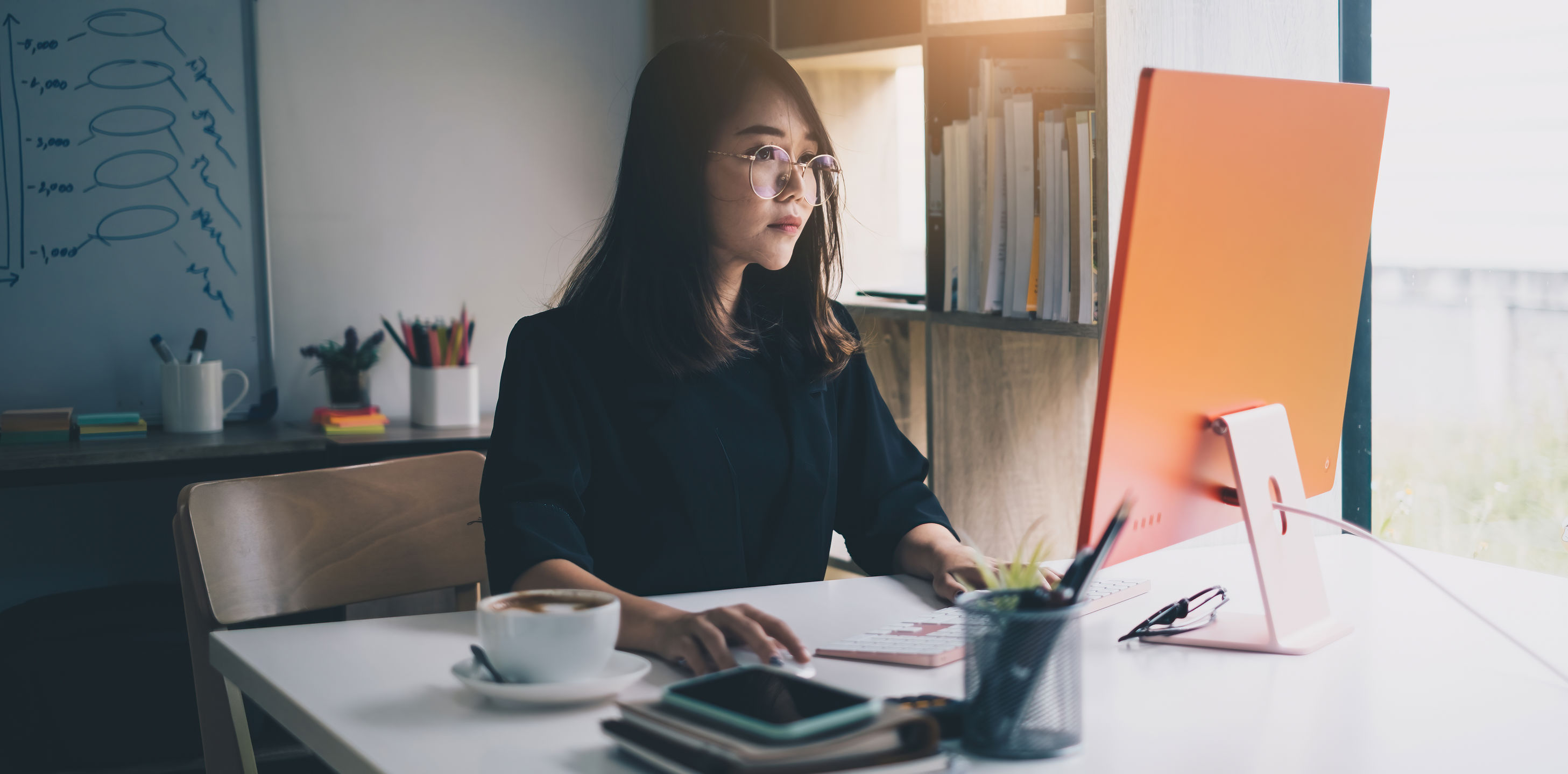 young woman working on a computer at home