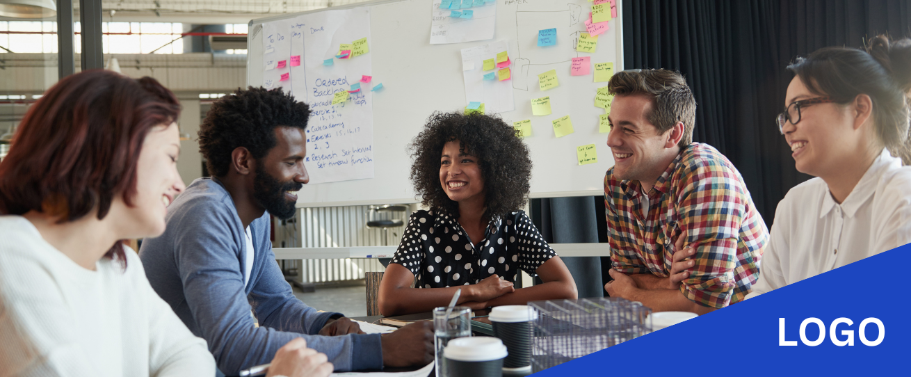 Team smiling sitting at a desk
