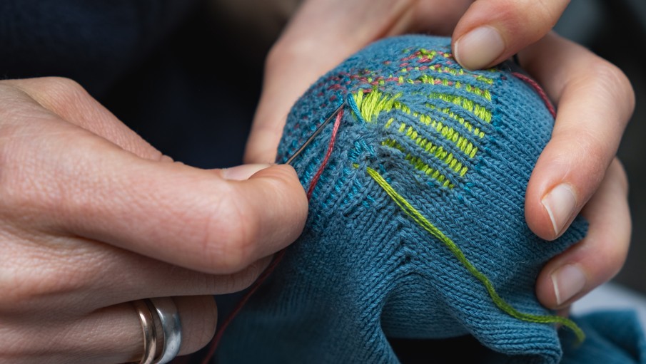 A person mending clothes.