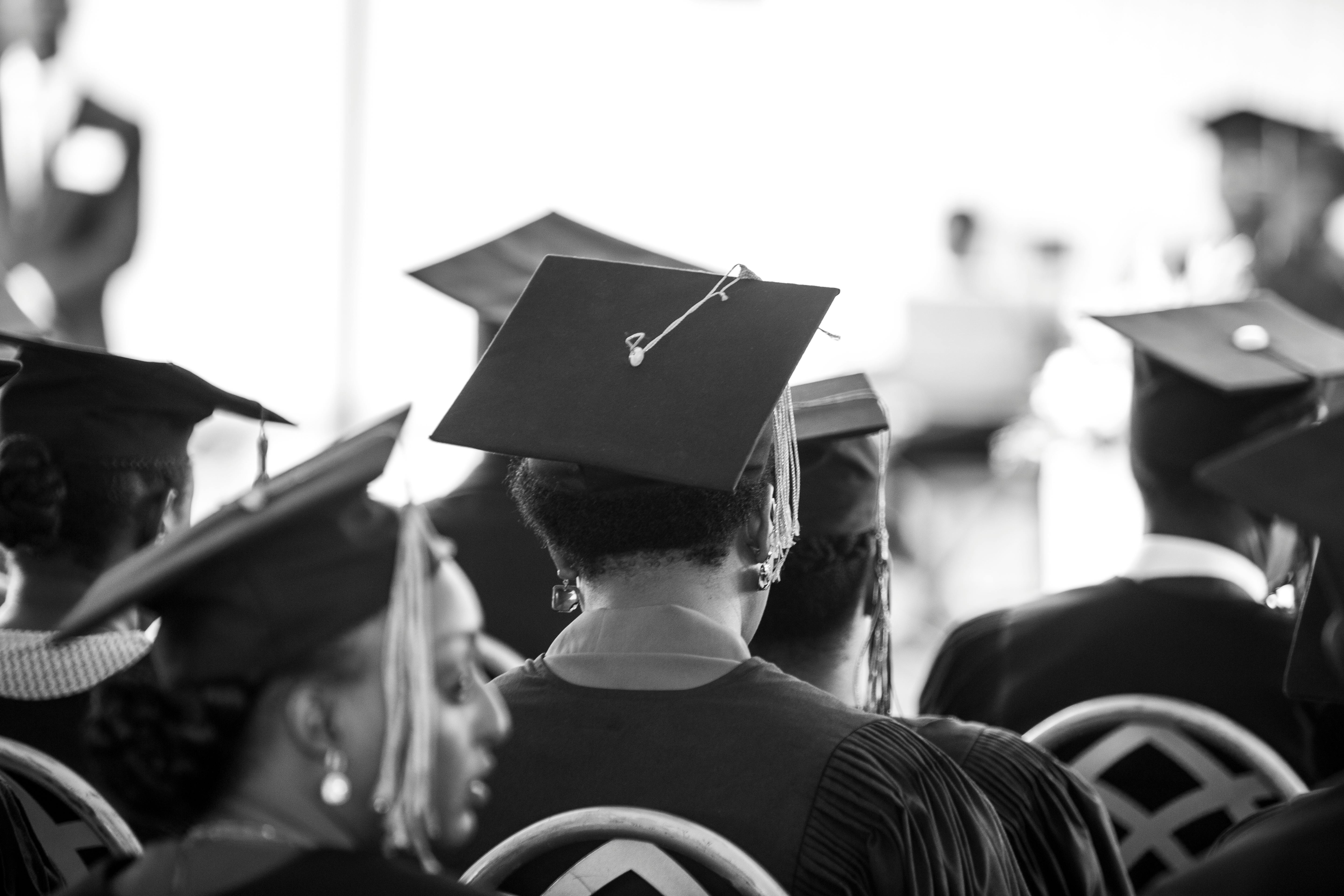 Back view of graduates in caps during a ceremony