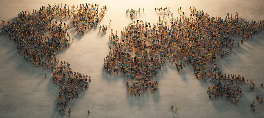 A graphic showing the representation of a world map formed by a large crowd of people.