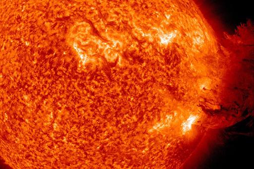 An image of the sun releasing a gush of magnetised plasma following a solar flare.