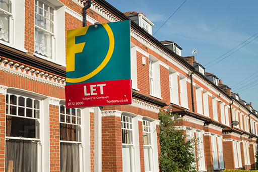 The image is a photograph of a row of houses. One has a ‘Let’ sign outside.