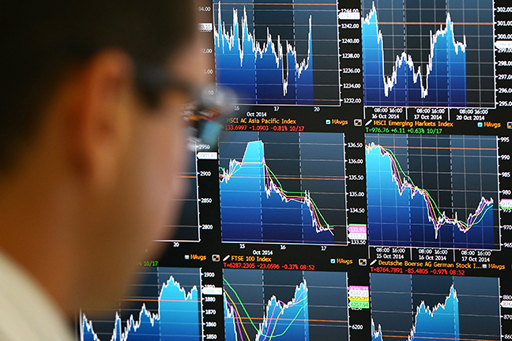The image is of a trader viewing various trading screens.