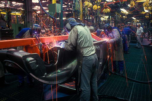 This is a photograph of workers in a car factory.
