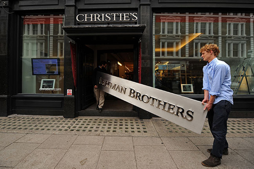 An image of the Lehman Brothers sign being carried into Christie's auction house.