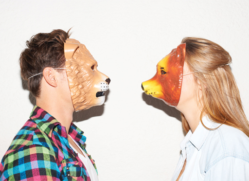 A photograph of two people wearing animal masks.