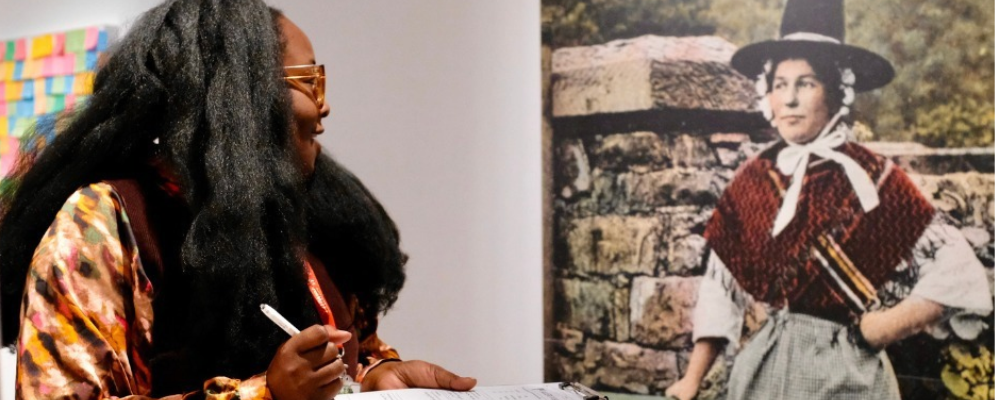 Participant looking at an artwork depicting Welsh national costume