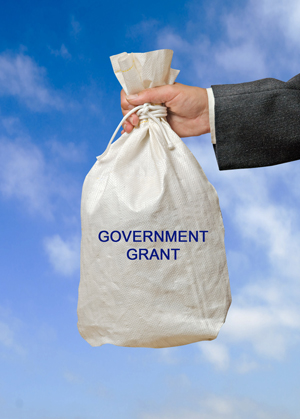 Man holding a bag labelled government grant.