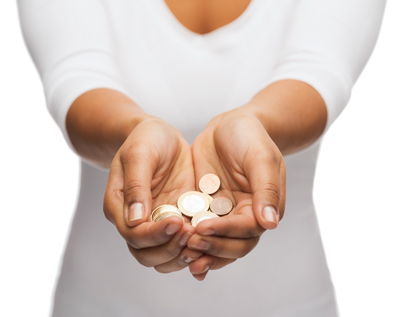 Woman holding out her cupped hands, which contain coins.