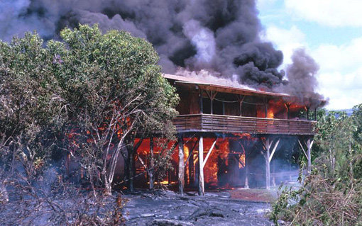 Figure 2 A burning house in Kalapana, Hawaii, surrounded by a thin sheet of pahoehoe in 1990.