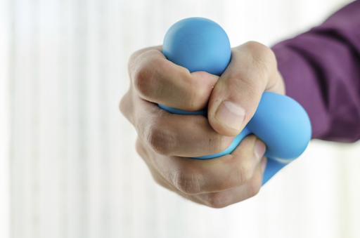 Photo of person squeezing a stress ball