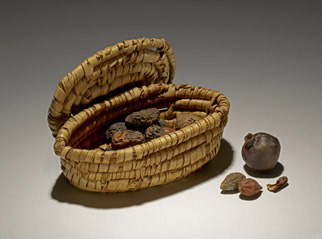 Oval fruit-basket of woven palm fibre with lid; contains figs and dates