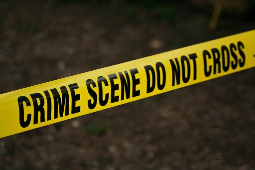 This is a photograph with a sign saying ‘Crime scene do not cross’.