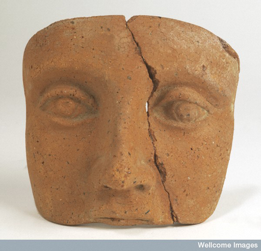 Face made of clay depicting only the eyes, nose and upper mouth.