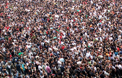 A crowd of people densely packed into an open space.