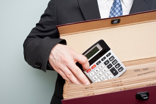 This image is of a person holding a calculator and a briefcase.