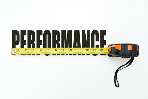 The word ‘Performance’ written out in capital letters with a tape measure running across the word.