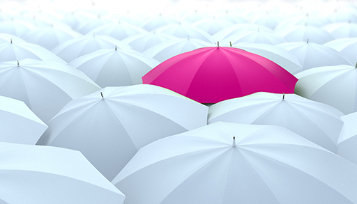 A pink umbrella stands out against a sea of white umbrellas.