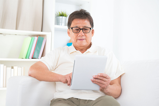 Man sitting down with computer tablet in hand.