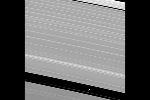 This is an image of Pan orbiting among Saturn’s rings.