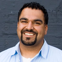 Photograph of a smiling 31-year-old Iranian man