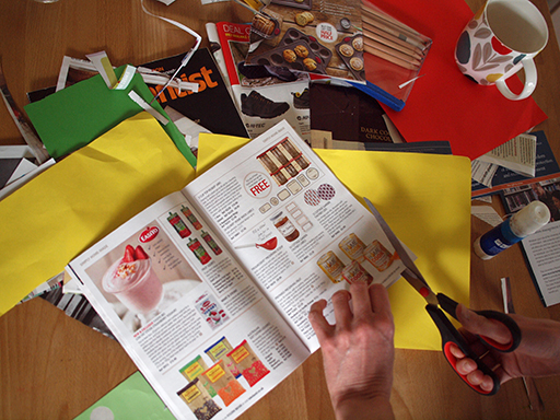 Someone cutting pictures out of a magazine to create a montage