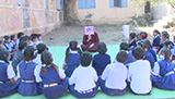 A teaching engaging her students through storytelling