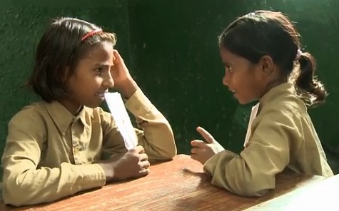 Two schoolchildren sitting at a desk