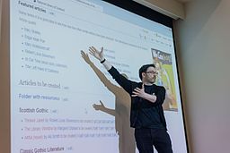 Person giving a presentation in front of a big screen