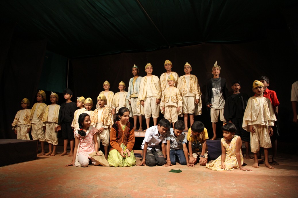 Group of children on stage for the play A Landcape (20-30 children in costume)