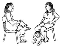 A health worker and pregnant woman sitting down at the first antenatal check-up. A baby sits playing by its mother’s feet.