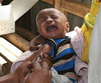 A baby cries out whilst being vaccinated.
