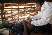 A pregnant woman is examined at home.
