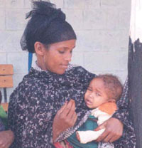 A mother holds her sick child.